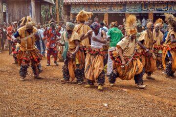 people in traditional dress dancing on brown field